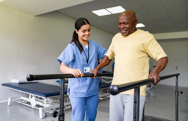 A physical therapist works with a patient after he was injured at work.