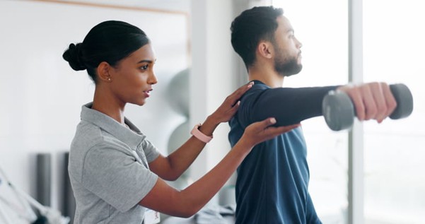 A physical therapist helps a patient after he's been injured in a car accident.
